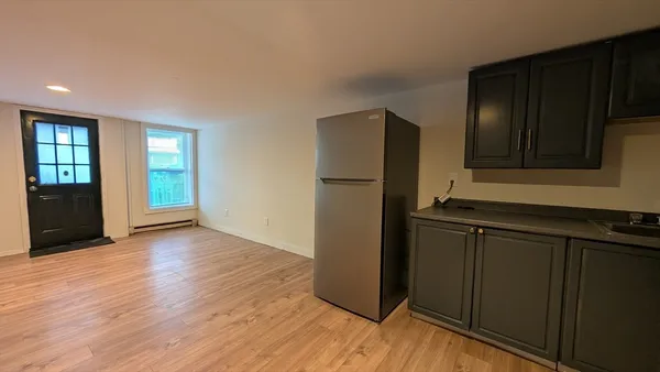 a kitchen with a refrigerator and a sink