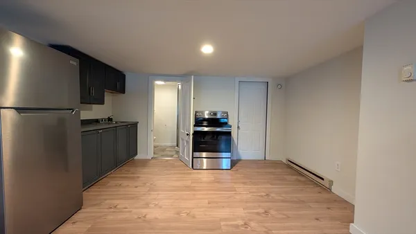 a kitchen with a refrigerator and a stove top oven
