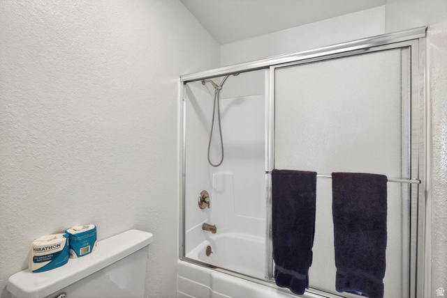 407 South Vasels Road, Unit 24 Brian Head, UT 84719 - Photo 21 of 63 Full bath with a textured wall and combined bath / shower with glass door