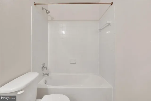 a bathroom with a bathtub and a toilet