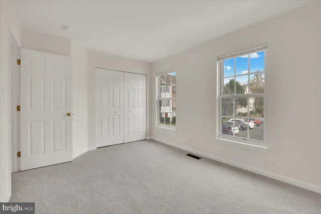 a view of an empty room with windows