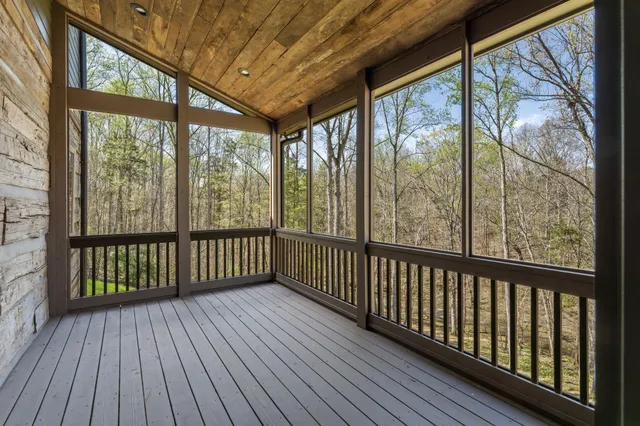 a view of a wooden deck with glass windows