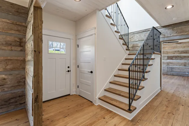 a view of a hallway with wooden floor and entryway
