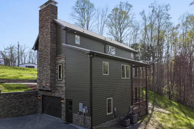 a backyard of a house with a yard and outdoor seating