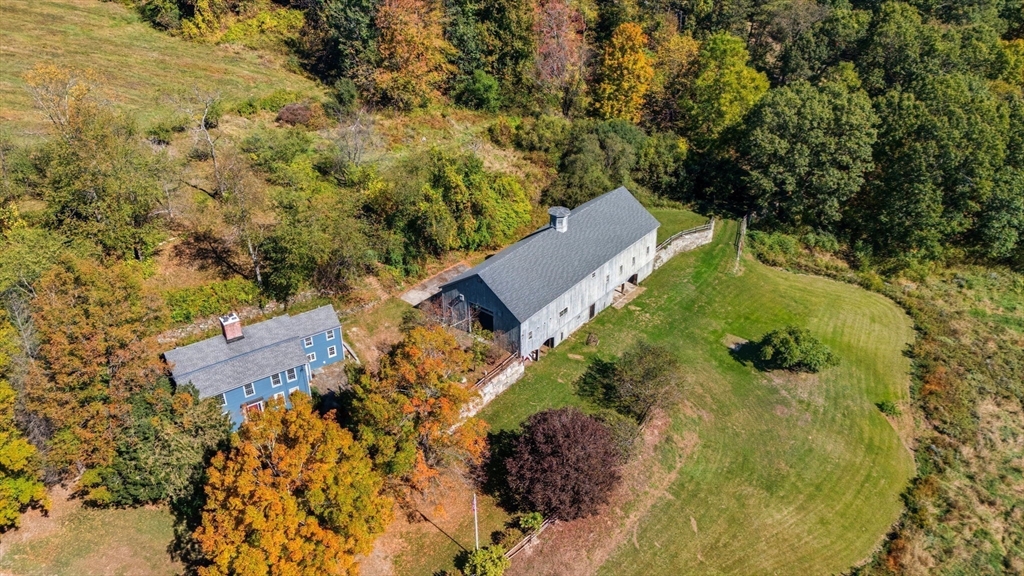 an aerial view of a house with yard swimming pool and outdoor seating