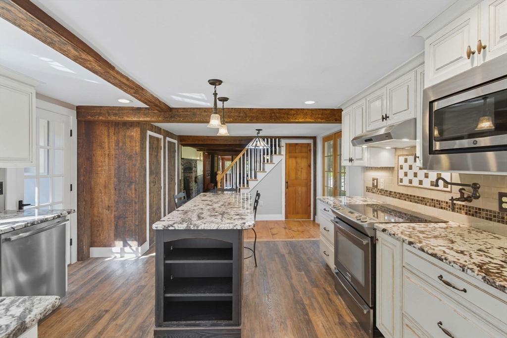 227 Boston Road Groton, MA 01450 - Photo 13 of 42 a kitchen with stainless steel appliances granite countertop a stove oven and a sink with cabinets
