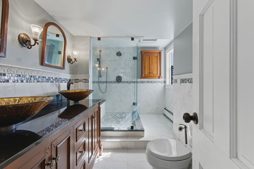 227 Boston Road Groton, MA 01450 - Photo 25 of 42 a bathroom with a toilet a sink and mirror