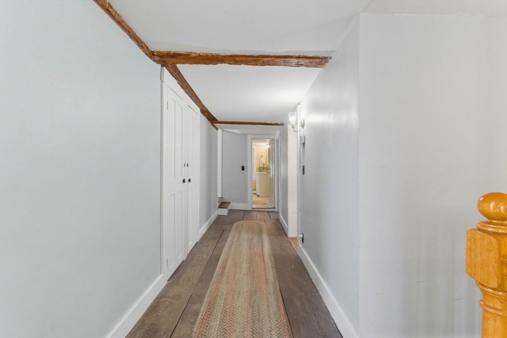 227 Boston Road Groton, MA 01450 - Photo 26 of 42 a view of a hallway with wooden floor and staircase