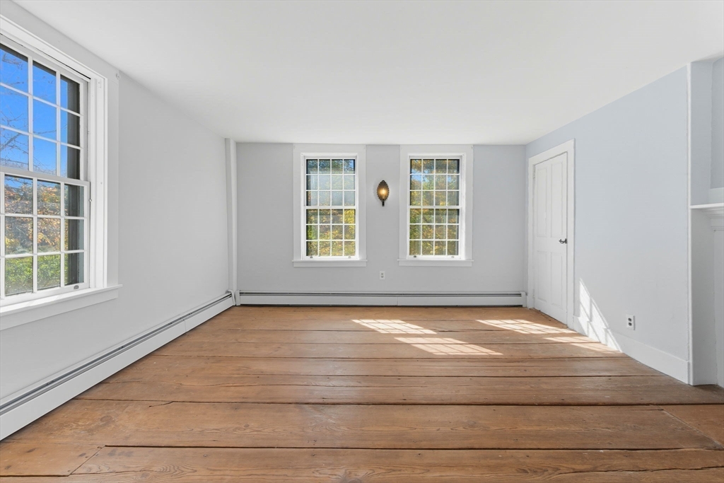 227 Boston Road Groton, MA 01450 - Photo 27 of 42 a view of an empty room with wooden floor and a window