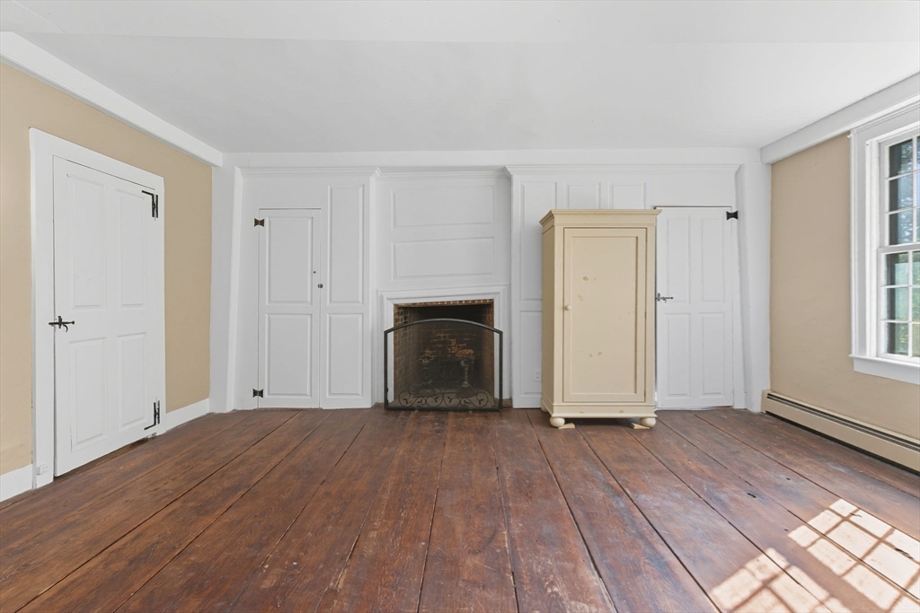 227 Boston Road Groton, MA 01450 - Photo 29 of 42 a view of empty room with wooden floor and fireplace