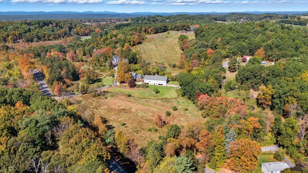 227 Boston Road Groton, MA 01450 - Photo 39 of 42 a view of a houses with a lush green hillside