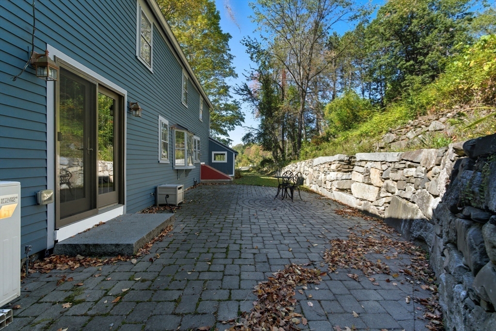227 Boston Road Groton, MA 01450 - Photo 5 of 42 a view of a backyard with chairs and a fire pit
