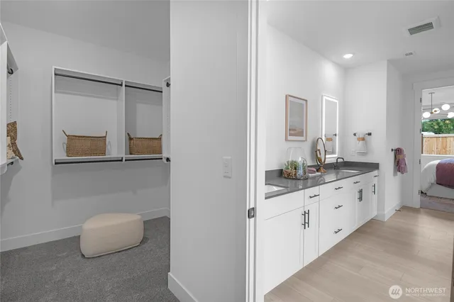 a bathroom with granite countertop a double vanity sink a mirror and a