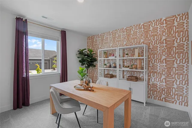 a view of a dining room with furniture and window