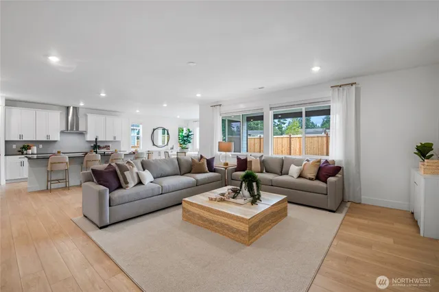 a living room with furniture and view of kitchen