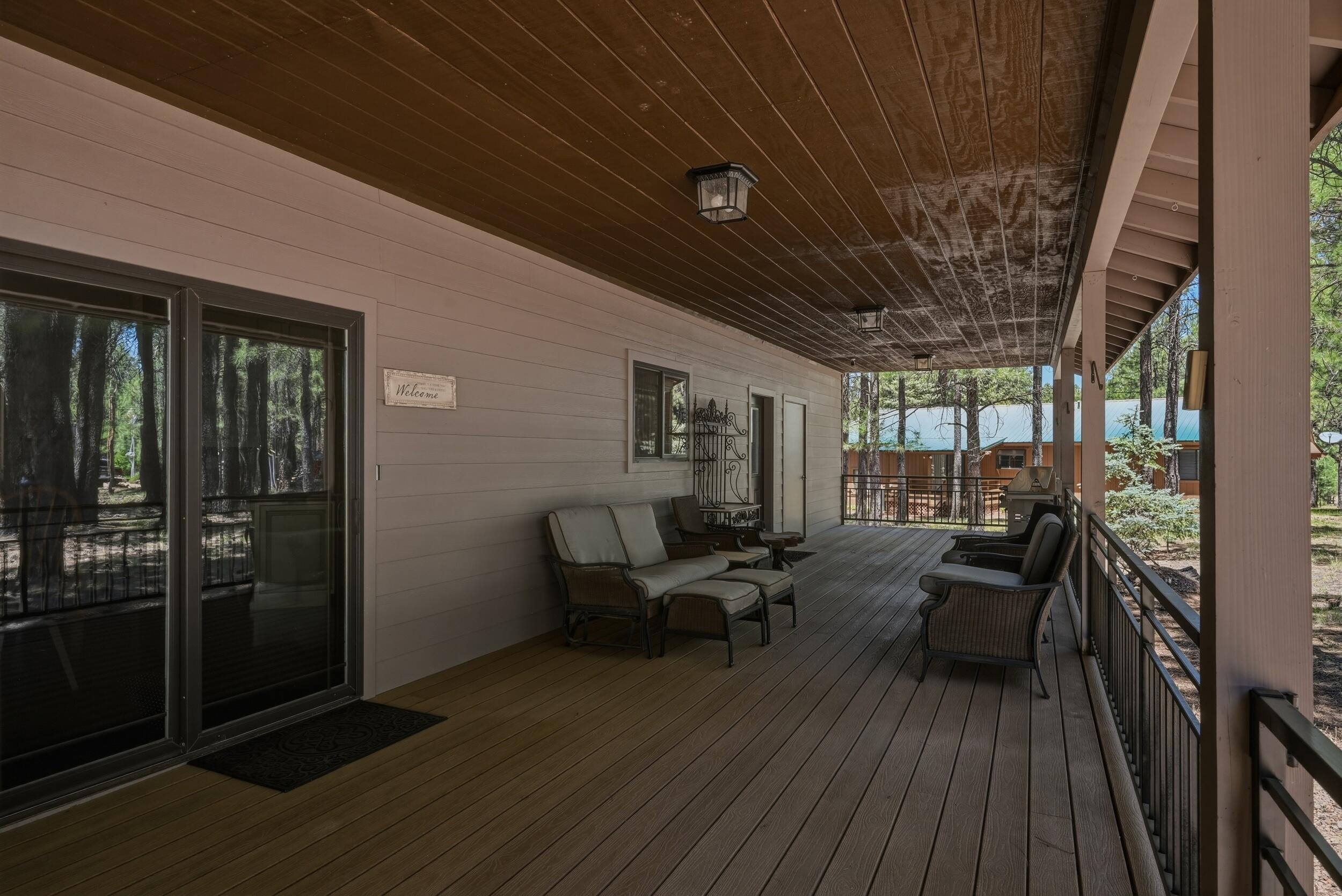 1233 Merzville Road Forest Lakes, AZ 85931 - Photo 30 of 39 a view of a patio with table and chairs with wooden floor