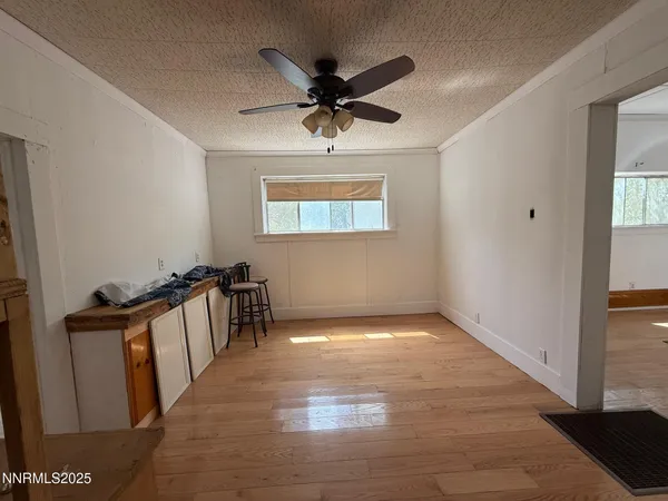 a view of a livingroom with a hardwood floor and a ceiling fan