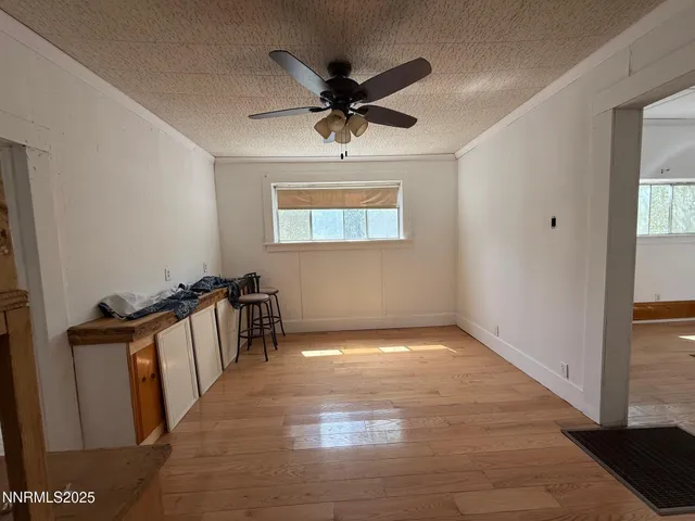 a view of a livingroom with a hardwood floor and a ceiling fan