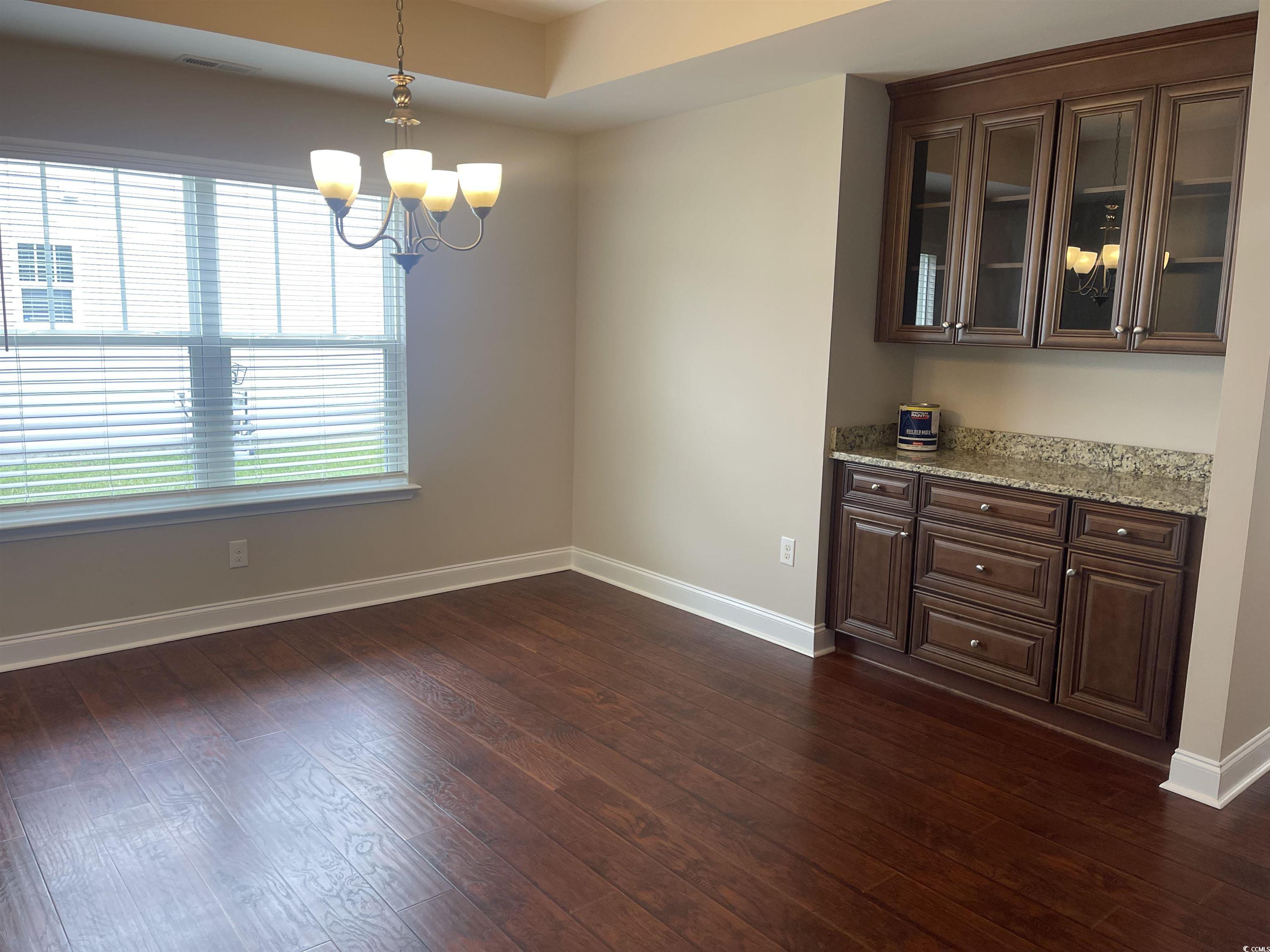 128 Cloey Road Myrtle Beach, SC 29579 - Photo 12 of 22 Unfurnished dining area with a chandelier and dark wood finished floors