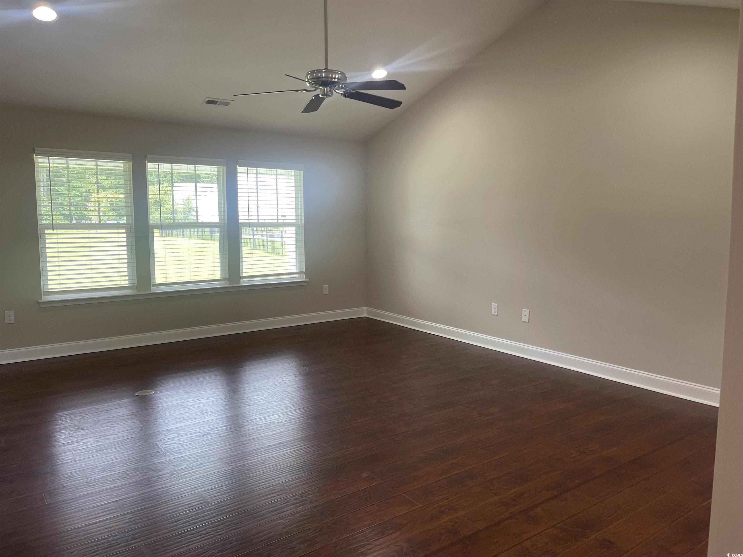128 Cloey Road Myrtle Beach, SC 29579 - Photo 13 of 22 Empty room featuring lofted ceiling, dark wood-style flooring, ceiling fan, and recessed lighting