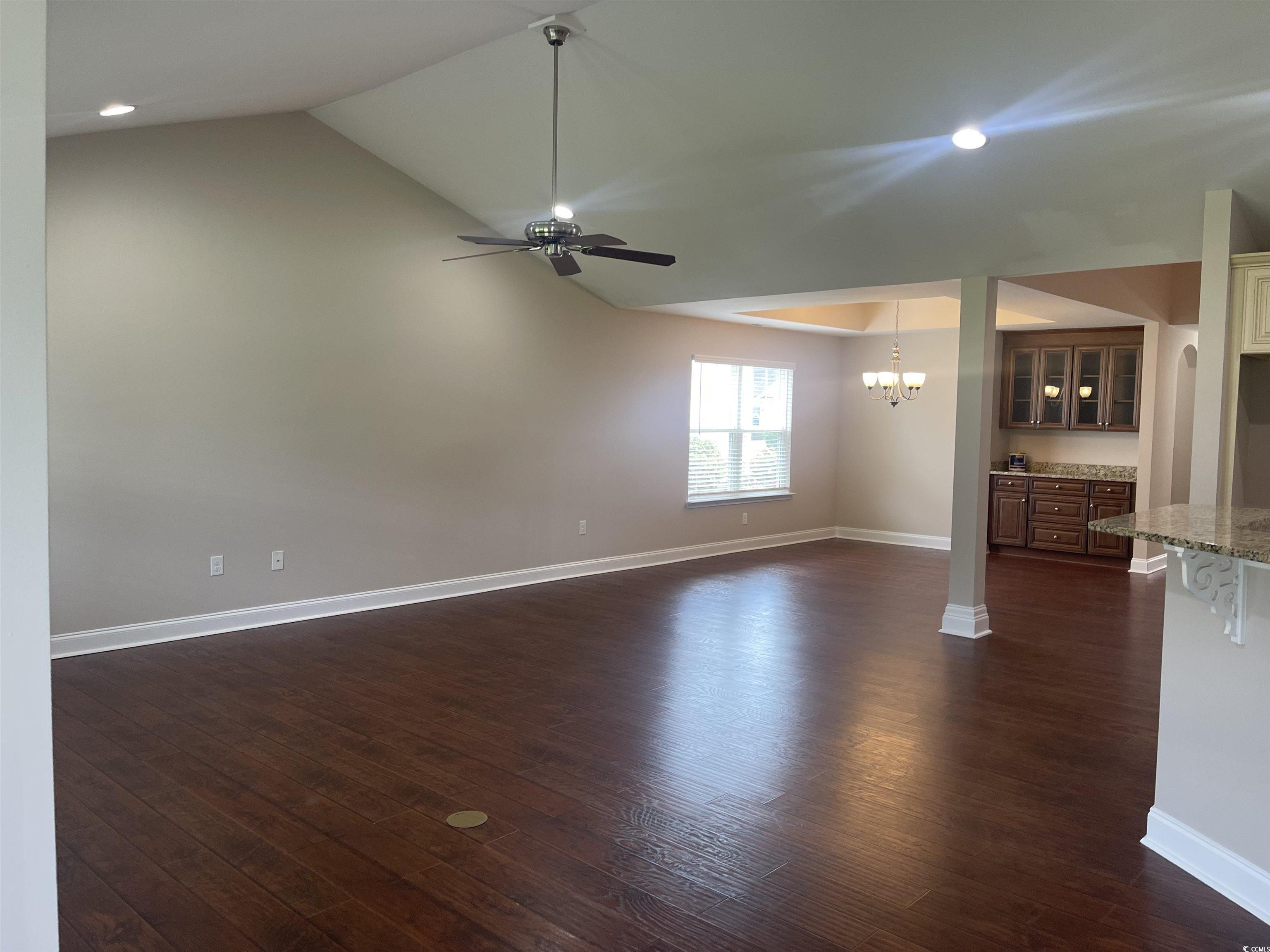 128 Cloey Road Myrtle Beach, SC 29579 - Photo 15 of 22 Unfurnished living room with dark wood finished floors, lofted ceiling, recessed lighting, a chandelier, and ceiling fan