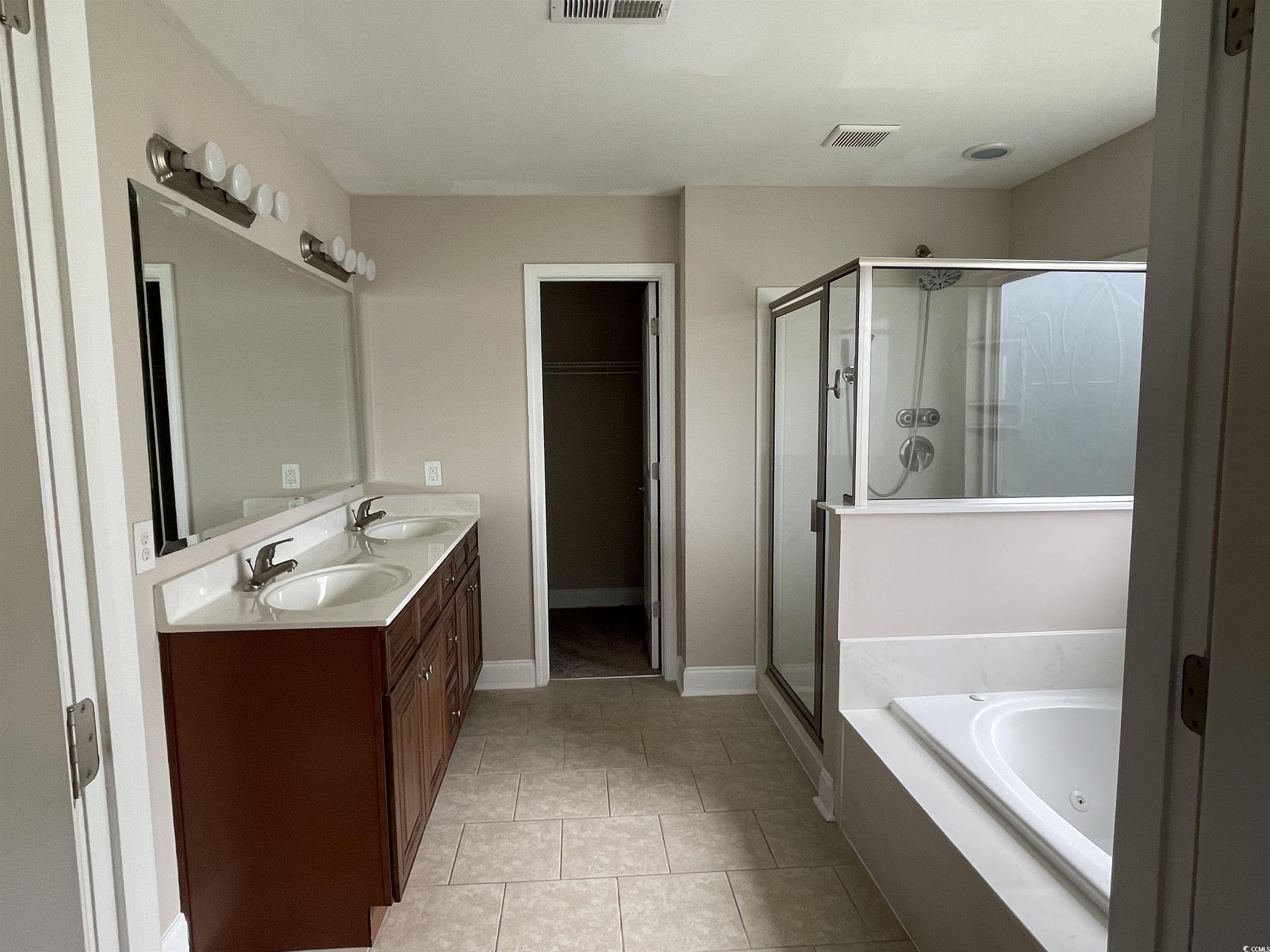 128 Cloey Road Myrtle Beach, SC 29579 - Photo 3 of 22 Bathroom featuring a stall shower, a garden tub, double vanity, and light tile patterned flooring