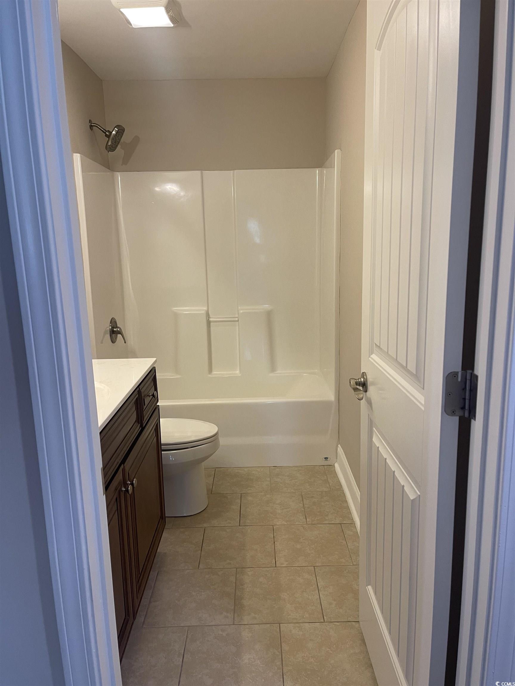 128 Cloey Road Myrtle Beach, SC 29579 - Photo 7 of 22 Bathroom featuring vanity, light tile patterned floors, and shower / bath combination