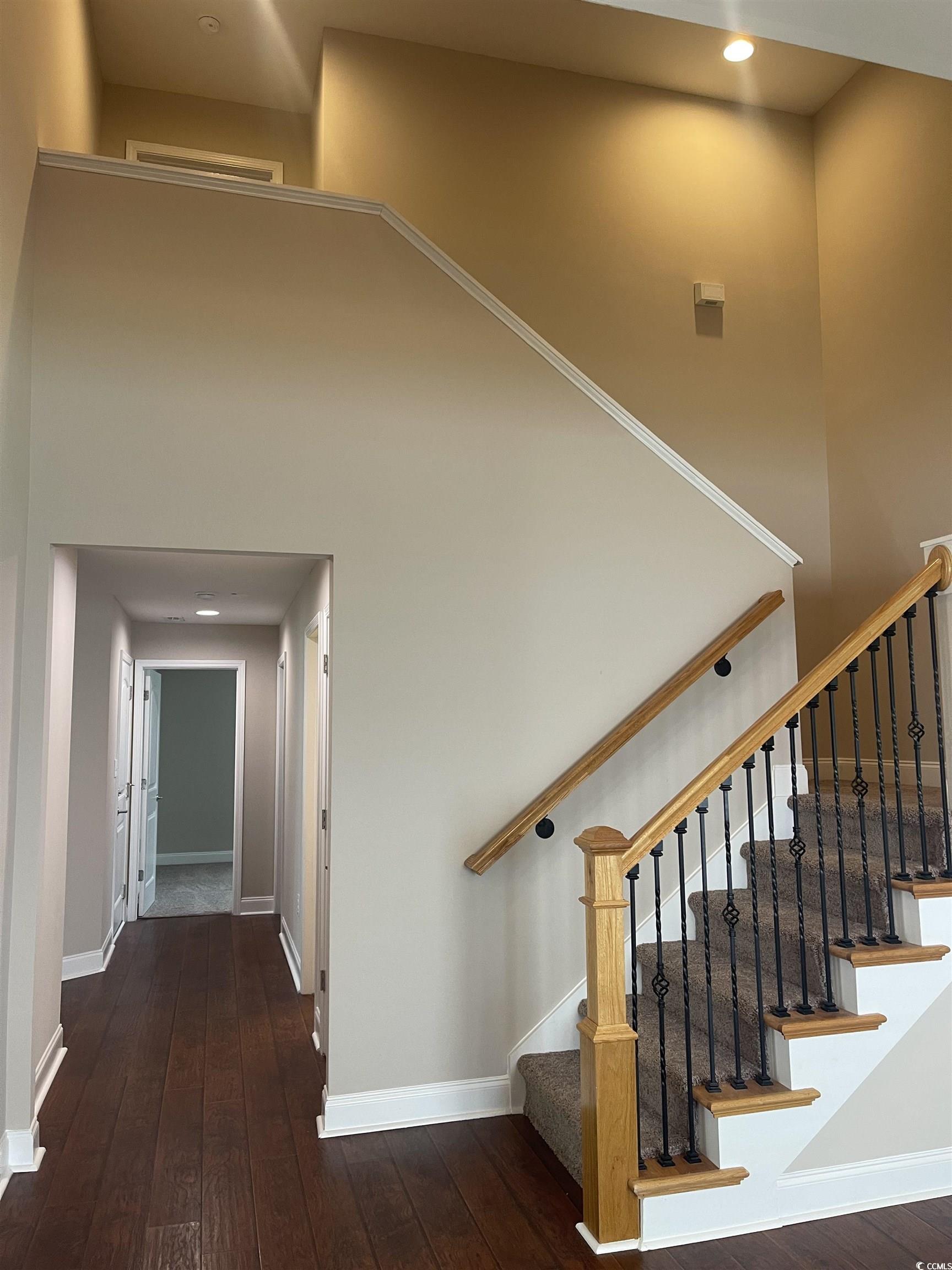 128 Cloey Road Myrtle Beach, SC 29579 - Photo 8 of 22 Stairs with a towering ceiling, hardwood / wood-style floors, and recessed lighting