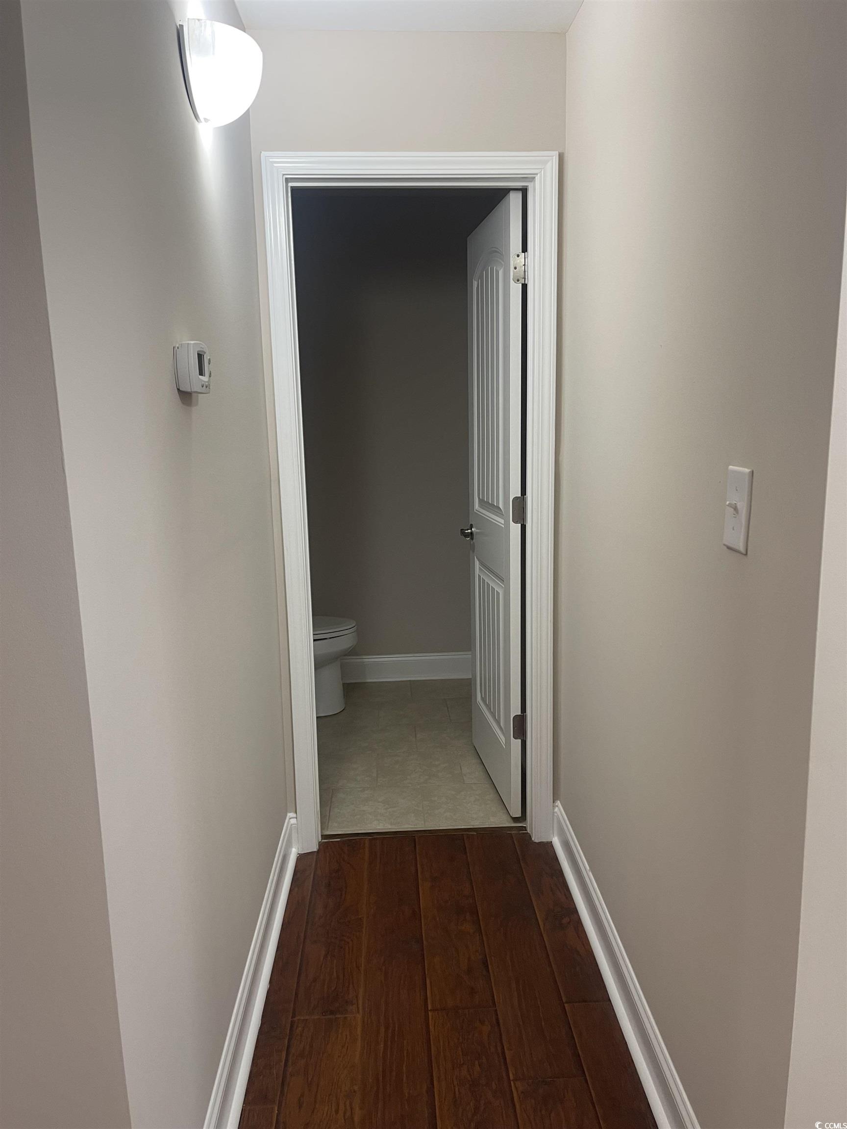 128 Cloey Road Myrtle Beach, SC 29579 - Photo 9 of 22 Corridor featuring dark wood-style flooring and baseboards