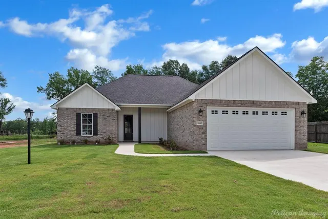 a view of a house with a yard and garage