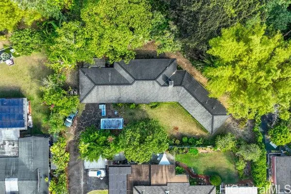 a view of an houses with a lush green hillside