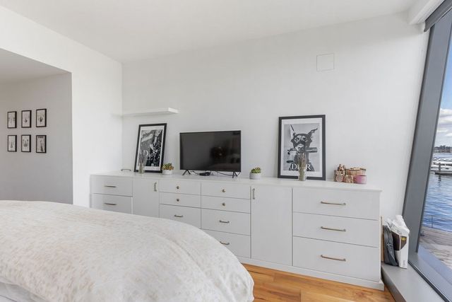 a bedroom with a bed and a flat screen tv in it