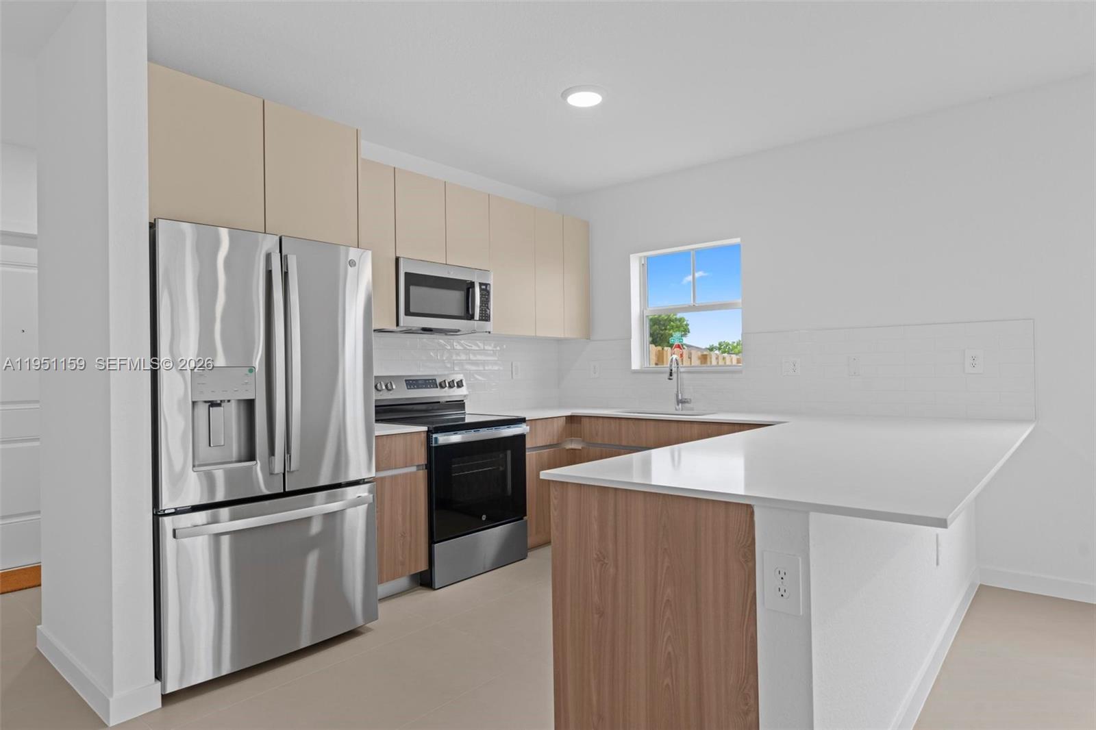 13355 Southwest 272nd Lane Homestead, FL 33032 - Photo 11 of 35 a kitchen with stainless steel appliances a refrigerator sink and stove