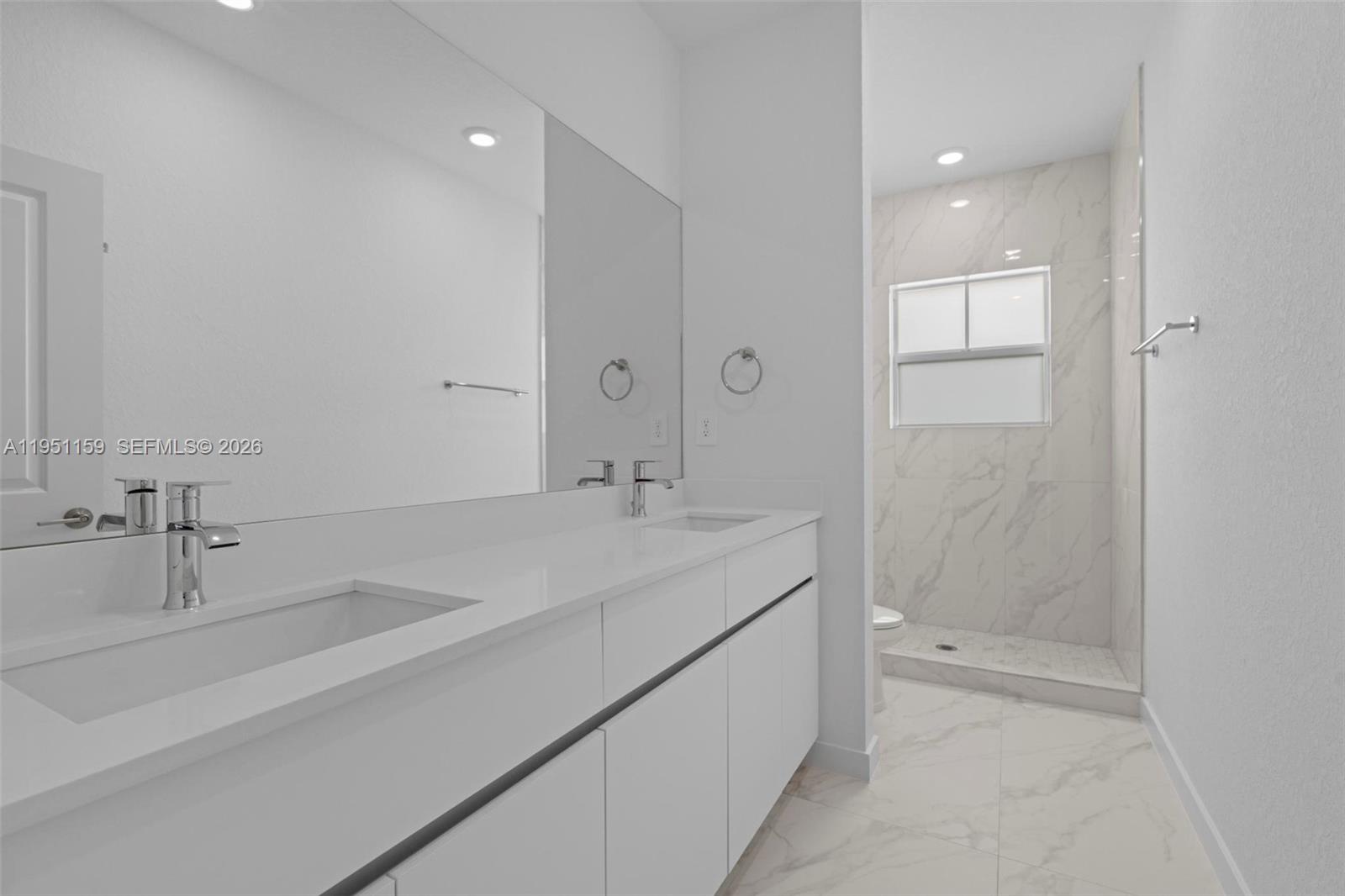 13355 Southwest 272nd Lane Homestead, FL 33032 - Photo 31 of 35 a bathroom with a sink and a mirror