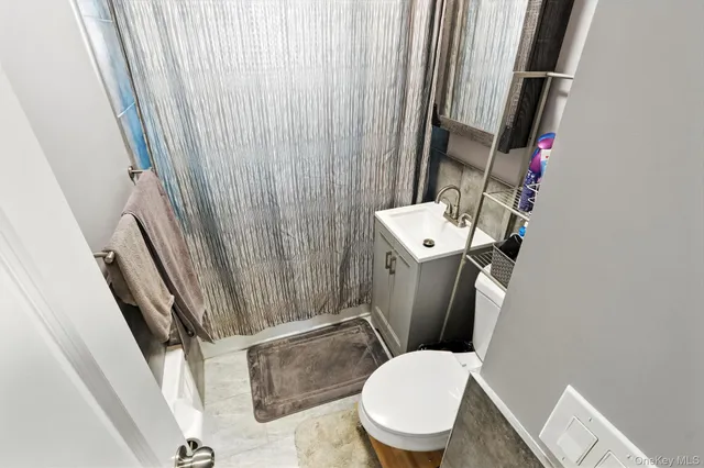 a white toilet sitting next to a small sink