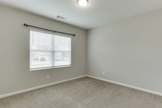 an empty room with closet area