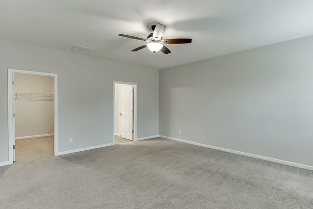 a view of empty room with ceiling fan