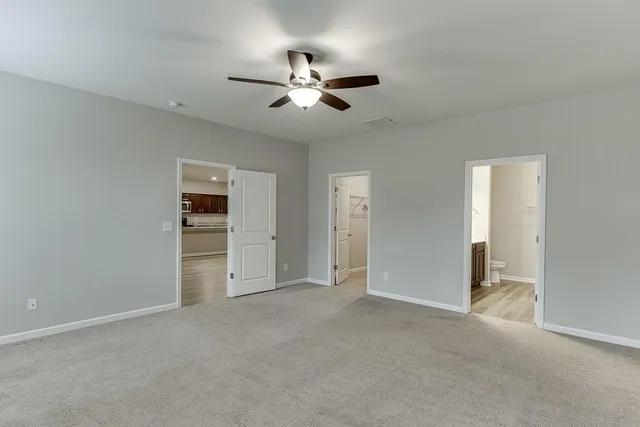a bathroom with a sink a toilet and a large mirror