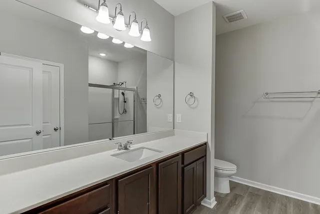 a bathroom with a sink a mirror and a shower