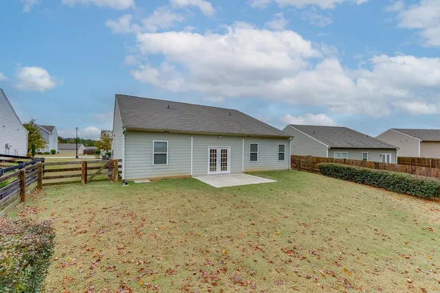 a view of a house with a backyard
