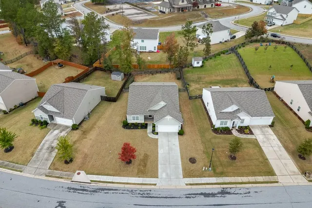 an aerial view of residential houses with outdoor space