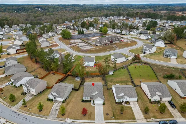 an aerial view of residential house with parking