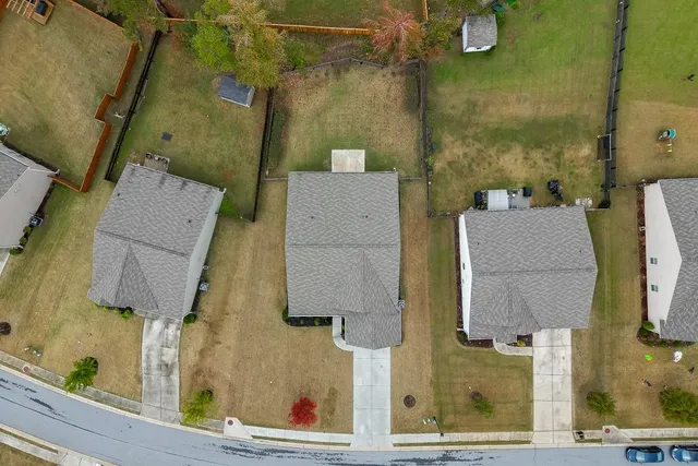 an aerial view of a house with swimming pool and patio
