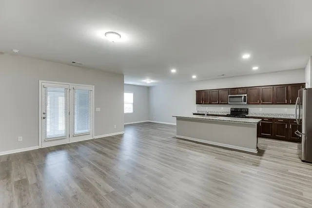 a view of kitchen with sink and wooden floor