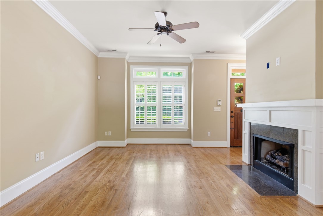 204 Butler Avenue Greenville, SC 29601 - Photo 6 of 26 Hardwood floors and a welcoming fireplace create a cozy, inviting atmosphere.
