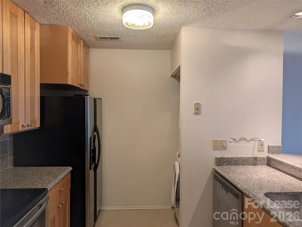 a kitchen with a refrigerator and a sink