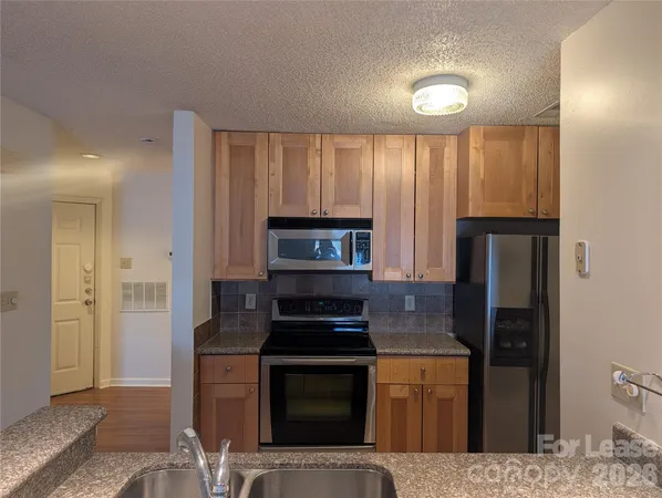 a kitchen with a refrigerator stove and microwave