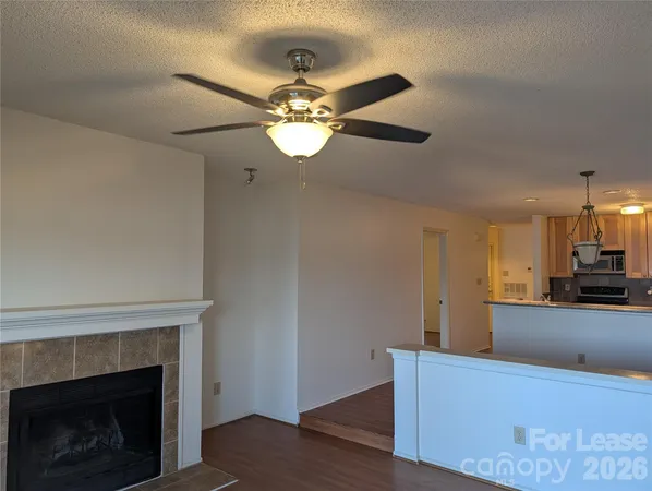 a view of a kitchen with a sink a ceiling fan and hardwood floor