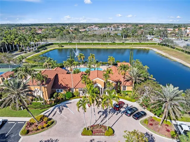 an aerial view of residential houses with outdoor space and swimming pool