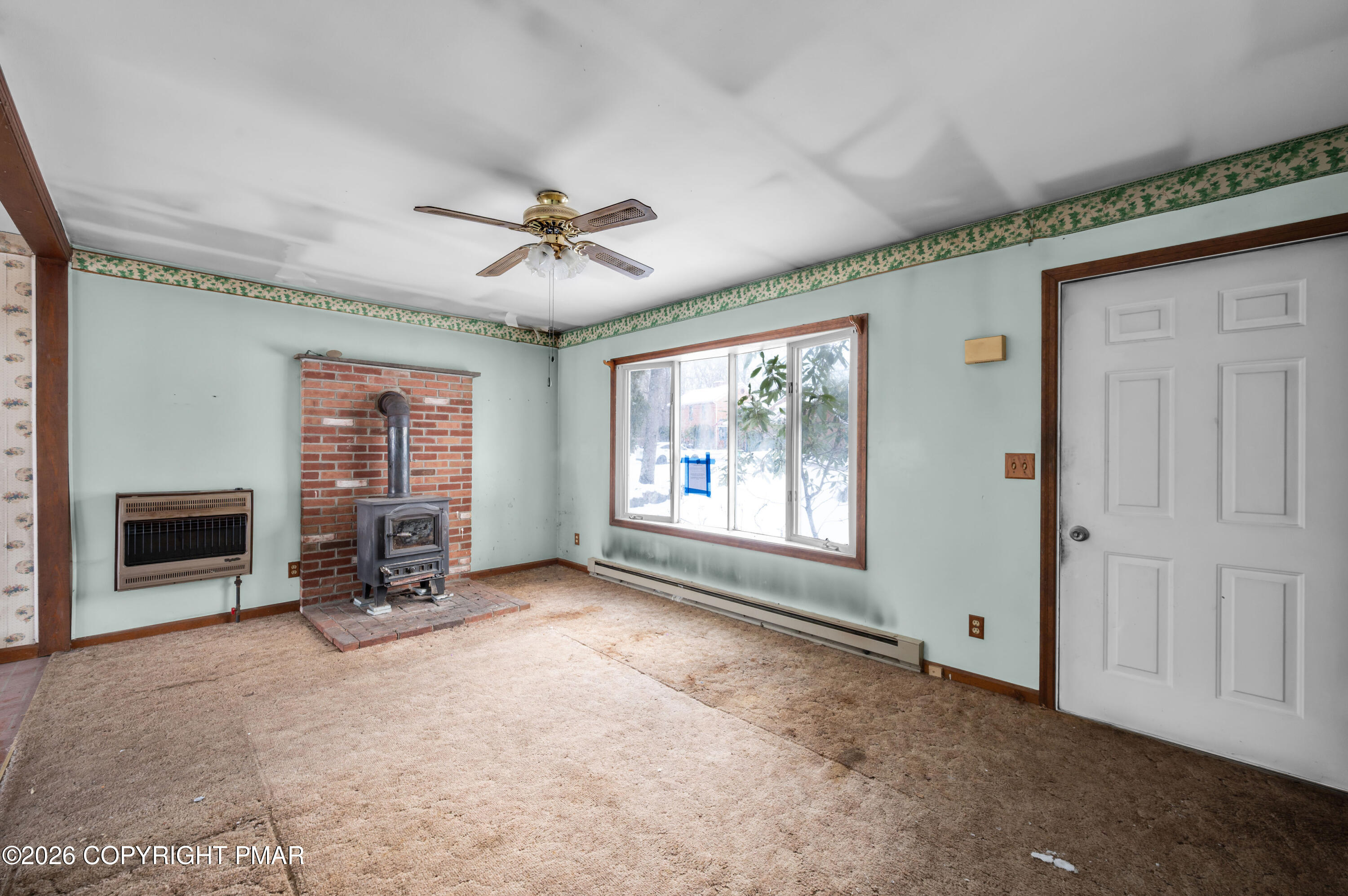 401 Schoolhouse Road East Stroudsburg, PA 18302 - Photo 5 of 21 a view of a livingroom with a fireplace and window